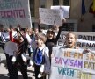 O fetiţă a purtat o pancardă pe care era scris "Vrem şi noi în Capitală, patinoare ca la ţară"