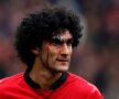Fellaini, lovit cu cotul în figură de Gerrard, a jucat cu arcada dreaptă spartă // Foto: Reuters
