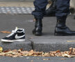 URMELE TERORII. Pe o stradă în apropiere de sala de concerte Bataclan, un pantof sport abandonat alături de ghetele poliţiştilor care au împînzit zona Foto: Reuters
