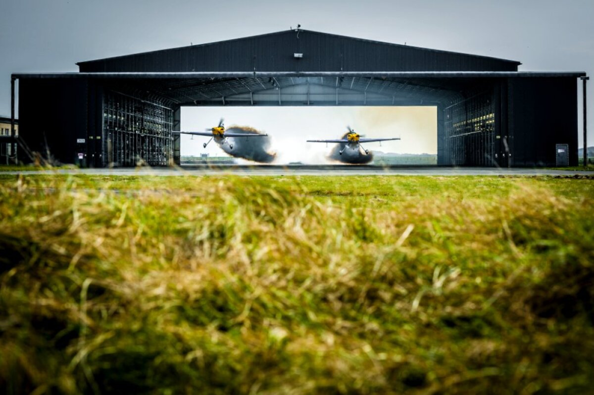 FOTO&VIDEO Zbor nebun de record mondial » Doi piloţi britanici au zburat în formaţie prin interiorul unui hangar!