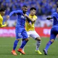 Chinezii nu l-au putut opri pe Tevez nici înfigându-i mâna-n piept // Foto: AFP