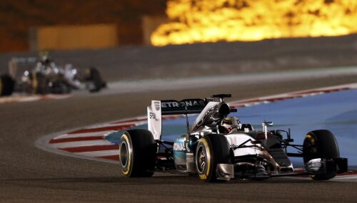 Lewis Hamilton în drumul spre victorie. În fundal nu sînt flăcări, ci un joc de lumini obținut de reflectoare
