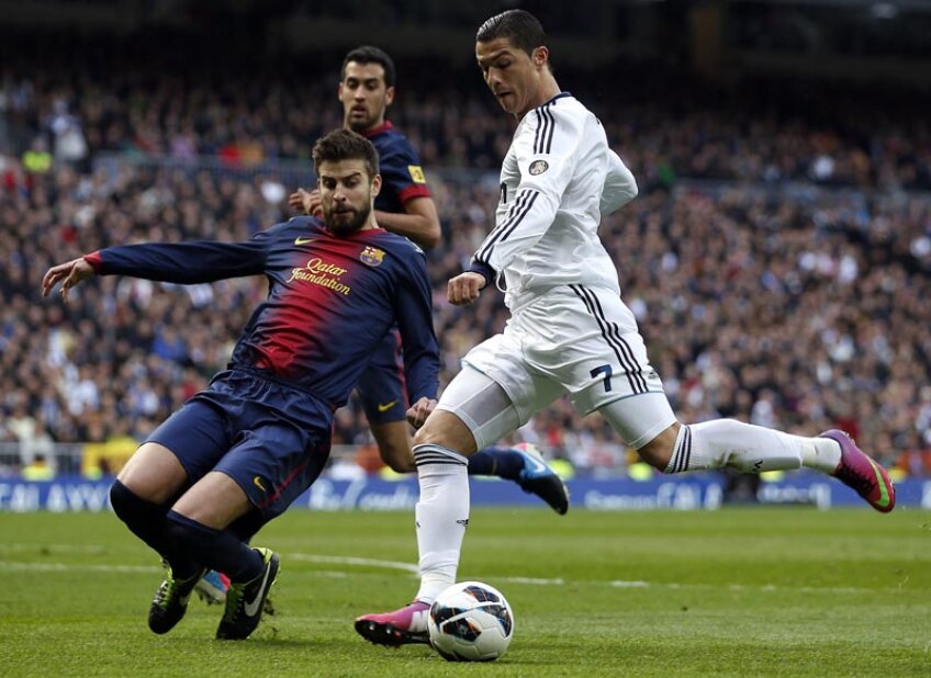 Alunecarea lui Pique n-are nici un efect. Cristiano Ronaldo (dreapta) lansează racheta înainte ca fostul coleg de la Man. United să-l blocheze // Foto: Reuters