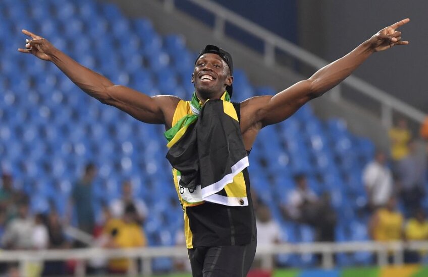 Bolt a trăit momentul victoriei de vineri noapte învăluit în steagul jamaican // Foto: Cristi Preda